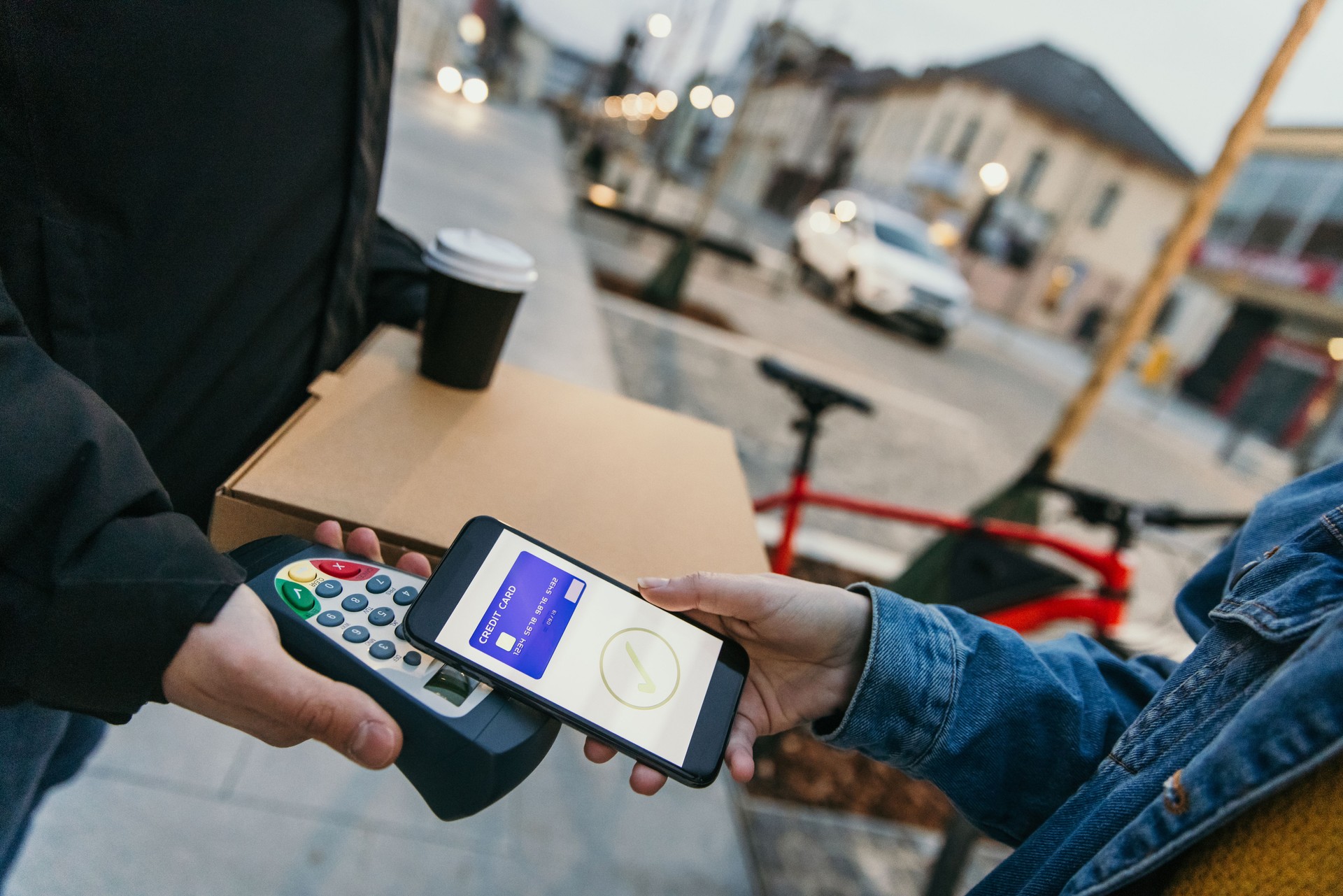 Close-up of customer hand making contactless payment